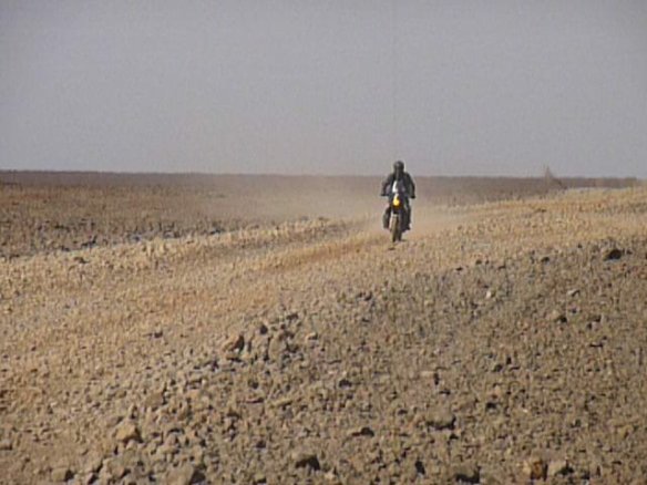 Me coming back to look for Paul and Marja who had had a puncture. very barren and rocky stretch of road