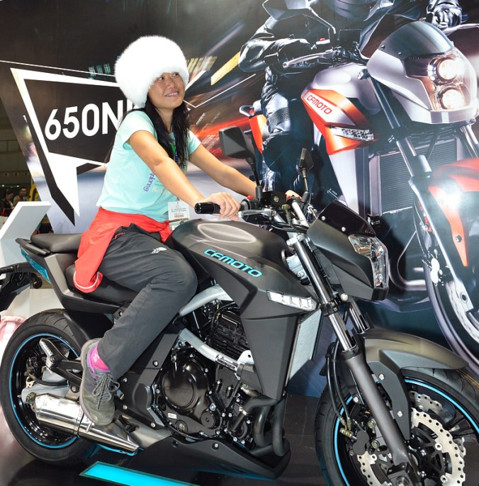 Fanny with her Tibetan white fox hat and the CF Moto 650 NK street bike that she will ride in Hong Kong. 