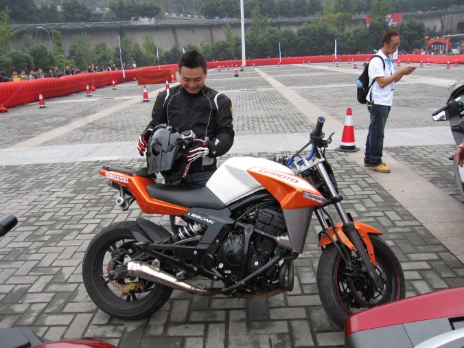 CF Moto's stunt rider -- Hu Hai  ( or as I call him Hu Li  Gan) ... I have seen many stunt riders and none as passionate, fun and skillful as Hu. Great guy. 