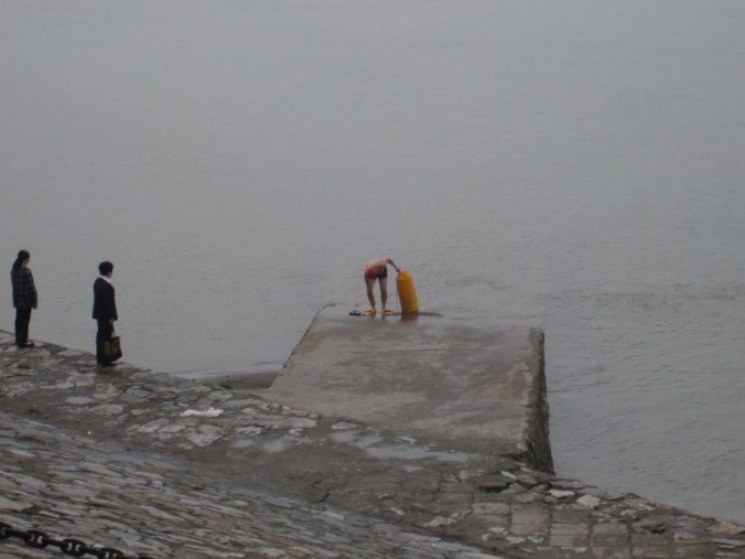 Local guys attaching themselves to buoys and floating across river